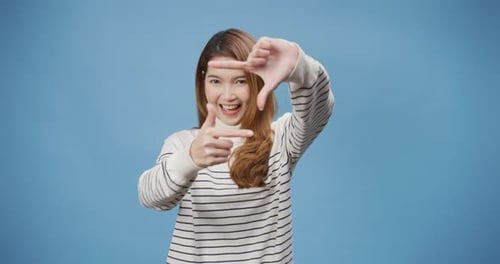 Smiling Woman Making Framing Gesture with Hands
