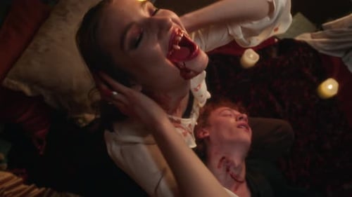 Portrait of Sinister Vampire Woman Holding Lifeless Head of Man with Bite Marks