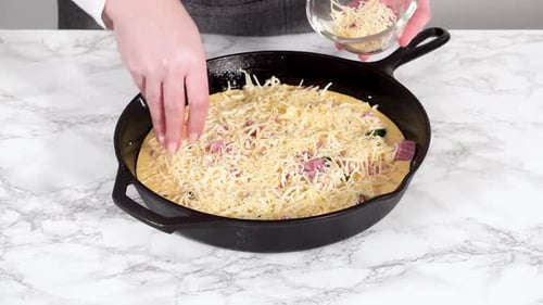 Preparing Spinach and Ham Frittata in Cast Iron Skillet