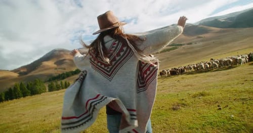 Woman Runs Joyfully Toward Sheep in Green Field