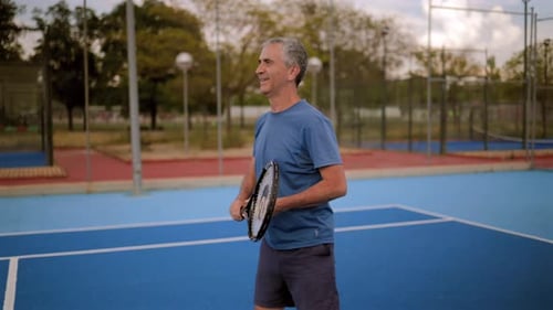 Elderly tennis player practices his serve on a blue court, demonstrating different stages of his tec