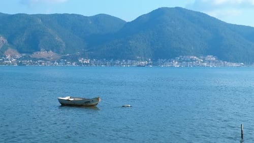 Empty Boat Against Mountain Hill