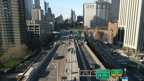 Busy Pavement in Middle of Multilane Road Surrounded By High Rise Buildings in Urban Borough