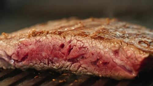 Cooking Beef Angus Steak in Restaurant Close Up Pieces of Hot Ribeye Steak Served on the Wooden