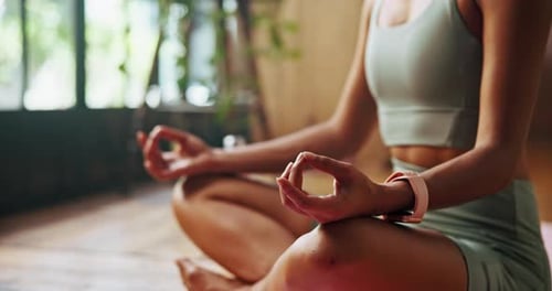 Woman Meditating in Lotus Position on Yoga Mat