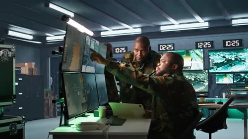 Men Analyze Data on Computer Monitors in Office