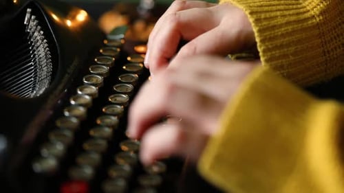 Hands Typing on Vintage Black Typewriter