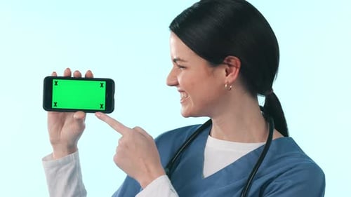Green screen smartphone, happy woman or nurse okay, point or advertising healthcare