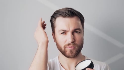 Man Applying Styling Product to Hair Close Up