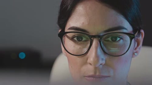 Female Programmer Working in Dark Office