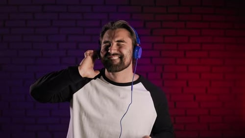 Man Listening to Music with Headphones and Phone