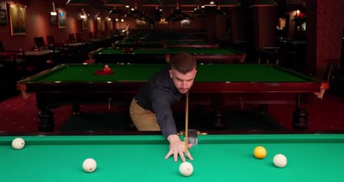 Man Playing Billiards at Pool Hall