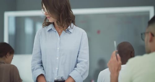 A female lecturer assisting a student during a test in a university classroom