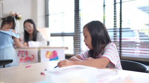 Children Drawing Pictures in Elementary School Classroom