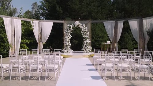 Elegant Outdoor Wedding Ceremony with Floral Arch