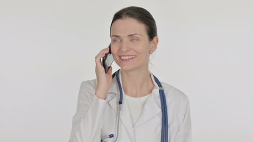 Female Doctor Using Smartphone and Talking on Phone