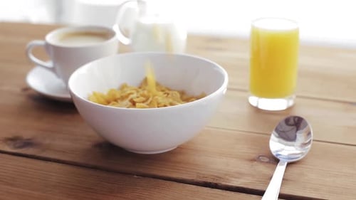 Golden Corn Flakes Being Poured for Breakfast
