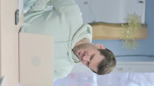 Adult Massaging Lower Back at Desk with Laptop