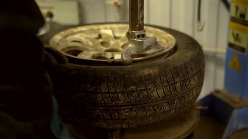 Tire Changing Machine Removing Worn Tire from Rim