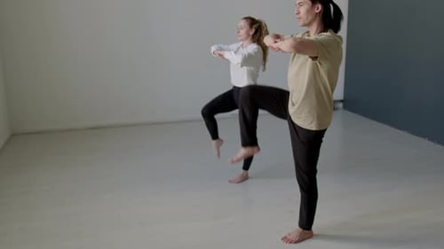 Couple of Dancers Doing Hip Rotation Exercise in Studio