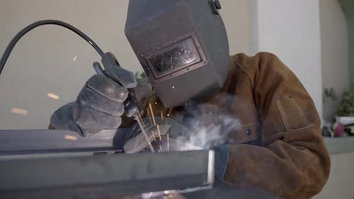 Worker Welding Metal with Protective Gear On