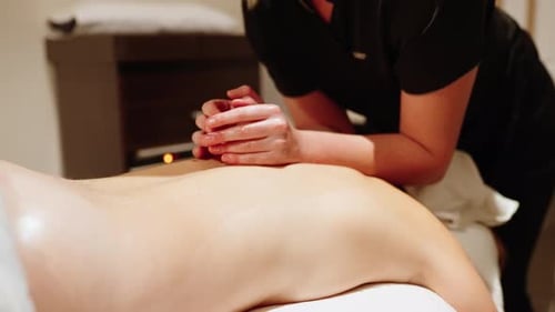 Woman Receiving a Relaxing Back Massage at Spa