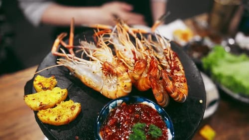 Cooked Shrimp with Red Sauce on Black Plate