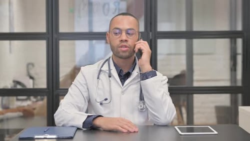 Doctor Talking on Phone in Medical Office