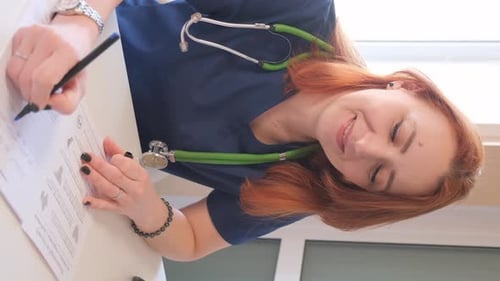 Smiling Young Woman Doctor Taking Notes