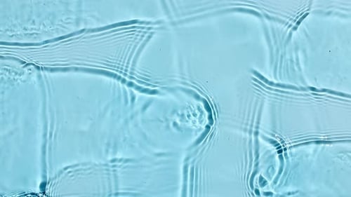 Abstract Ripples on Blue Water Surface