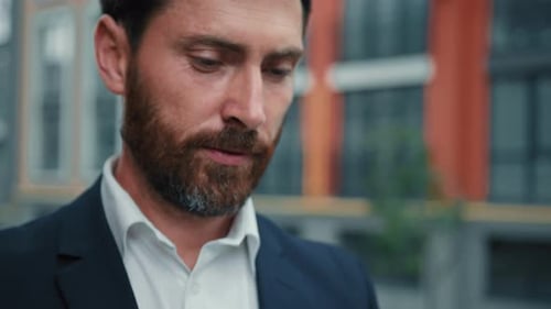 Inspired Successful Adult Caucasian Businessman Bearded Wealthy Man Stand in City Hold Smartphone