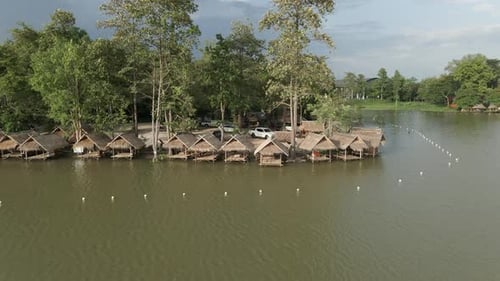 View Around the Lake with Huts on the Shore and Parked Cars