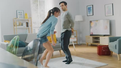 Happy Couple Dancing Together in Living Room