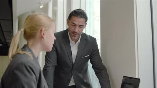 Collaborative Business Professionals Engaging in a Modern Office Environment with Teamwork