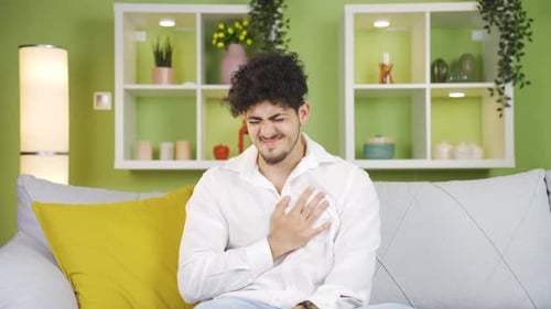 Young man having a heart attack.