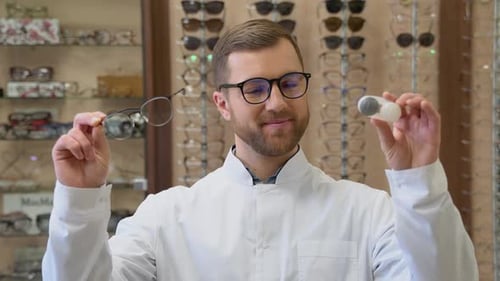 Ophthalmologist Hold Contact Lenses and Glasses in Hands Close Up