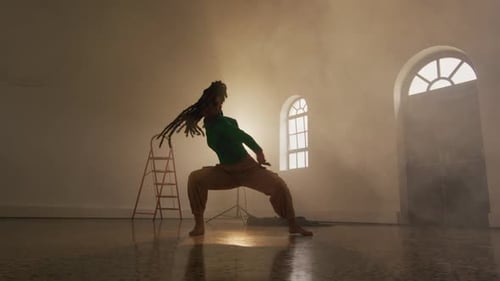 Portrait of biracial female dancer dancing in dance studio, slow motion