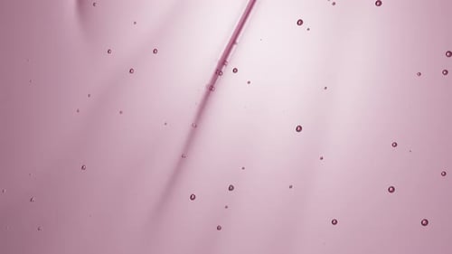Pink Fluid Gel with Bubbles Smoothly Flowing