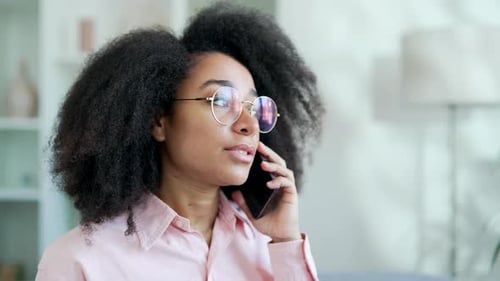 Woman Talking on Phone with Round Glasses, Indoors