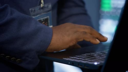 Extreme Close Up Shot of Man Working on Notebook in Data Center