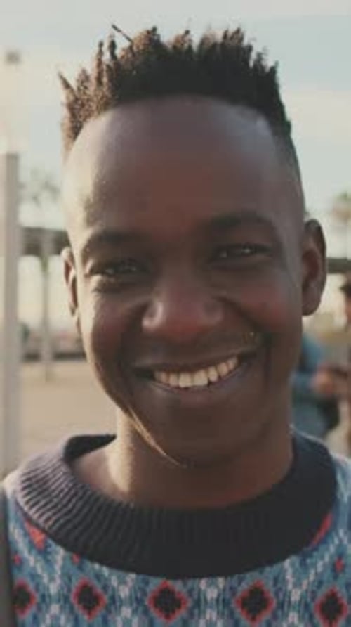 Close-up of a young man looking at the camera and smiling