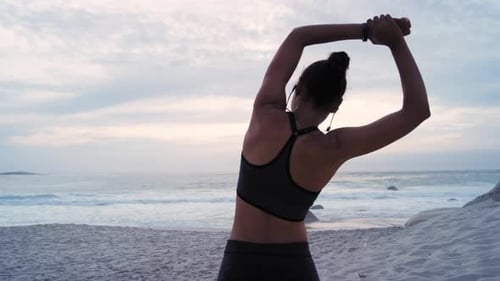 Fitness woman, back or earphones in beach stretching in sunset workout, training