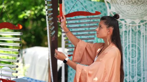 Young Woman Modeling and Dancing on a Garden Terrace Wearing Robe and Smiling