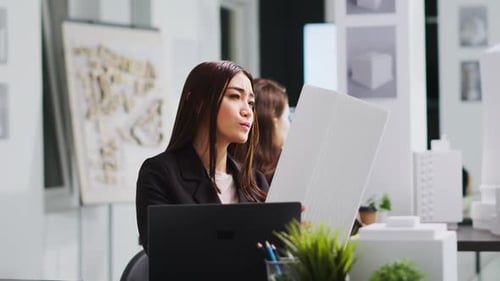 Portrait of Architect Studying 3d Building Model for Measurements