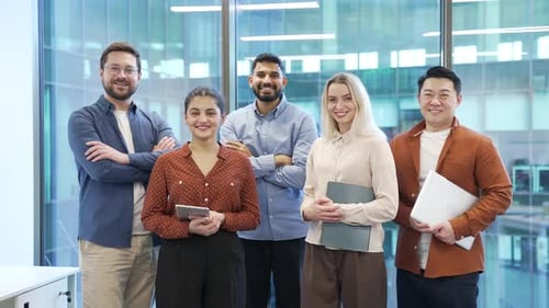 Portrait of group happy multiethnic team standing in modern office. Successful corporate colleague