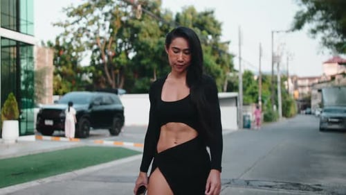 Confident Fitness Woman Walking in Urban Street
