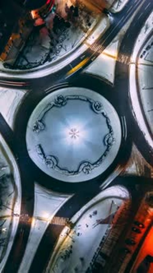 Vertical Aerial View Night Timelapse of Roundabout Road with Circular Cars in Small European City