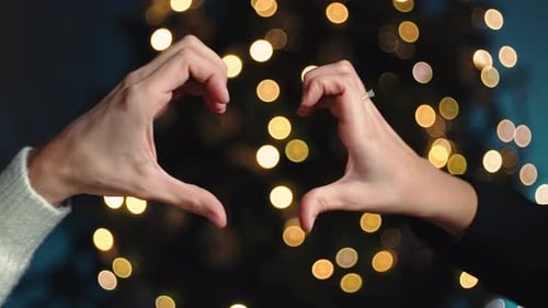 Couple Makes Heart Symbol On Christmas Night