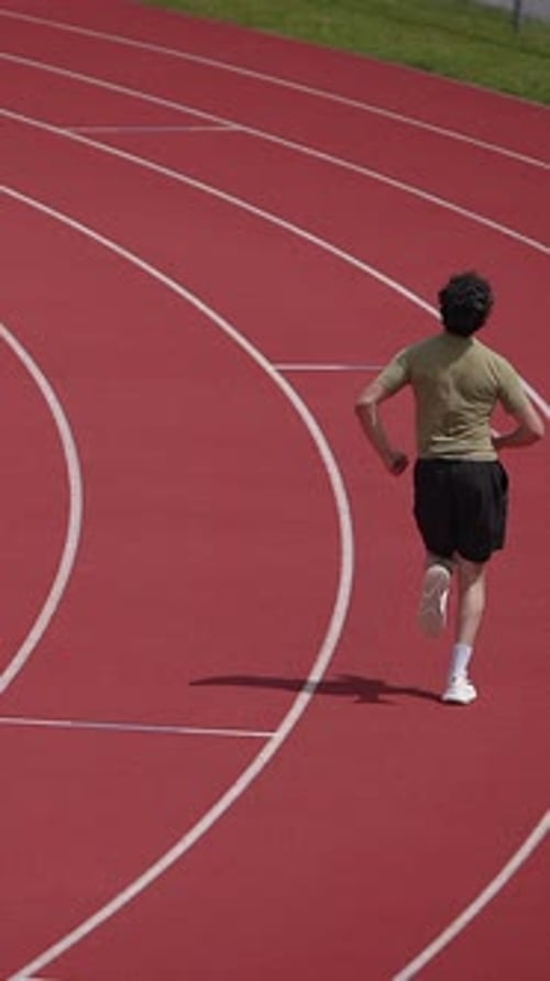 An Athlete is Jogging on a Track Field Engaging in a Healthy and Active Lifestyle