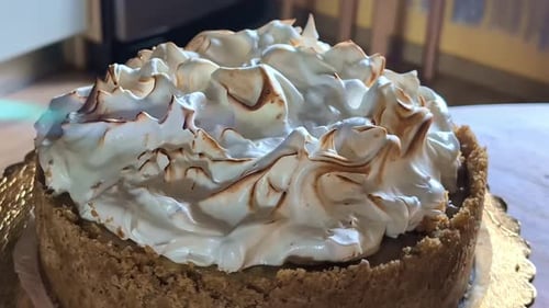 Using torch to melt cake top, close up view